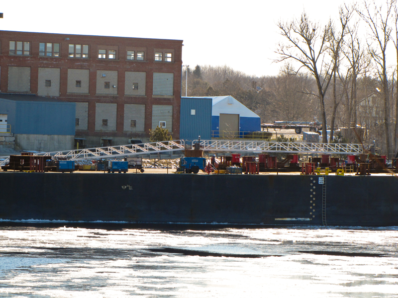 Aluminum gangway to dolphin to which barge is tied.