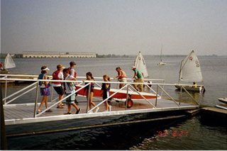 Rolling  a sailboat up the aluminum ramp